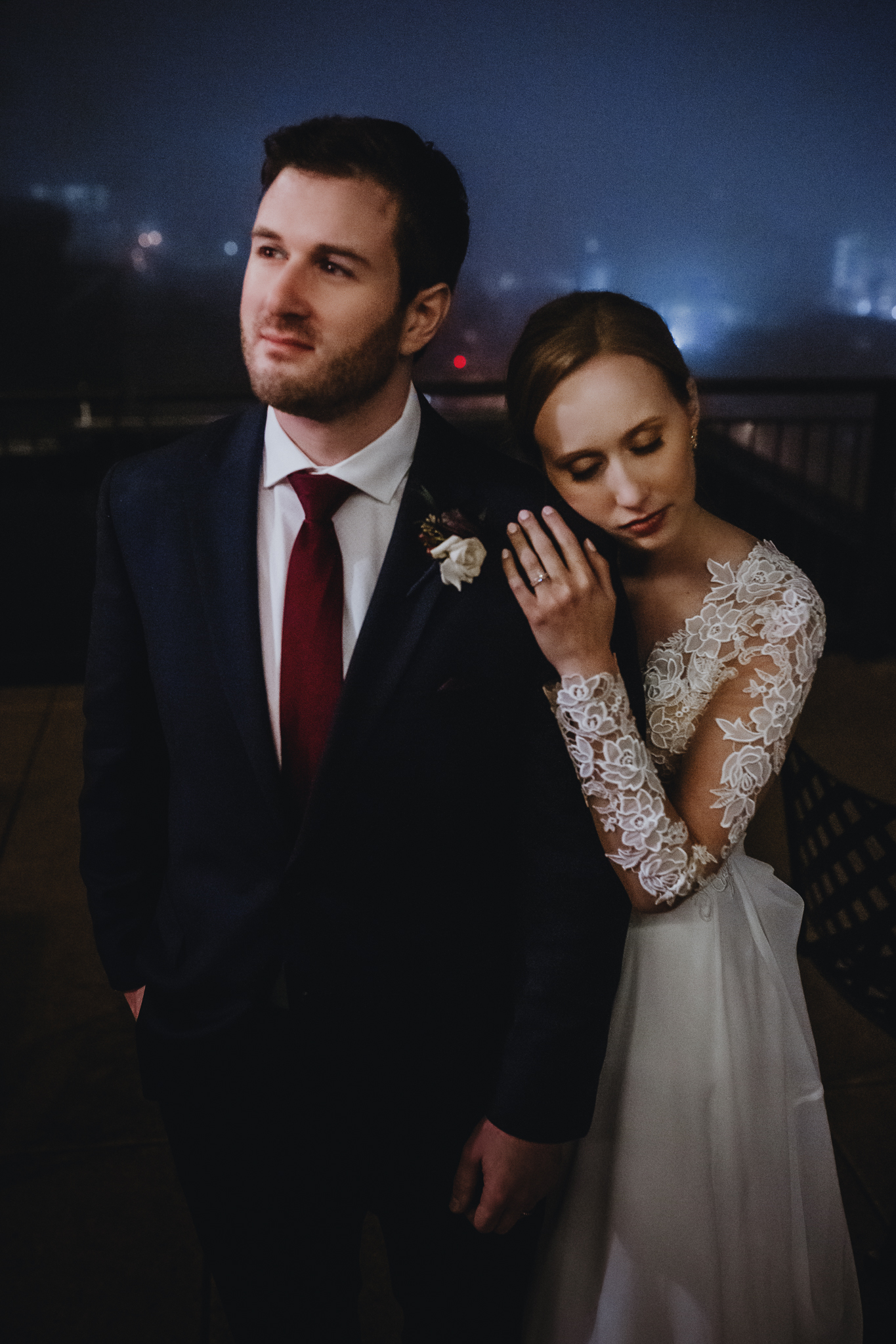 Bride leaning against her groom in the fog on the Edgewater Hotel rooftop.